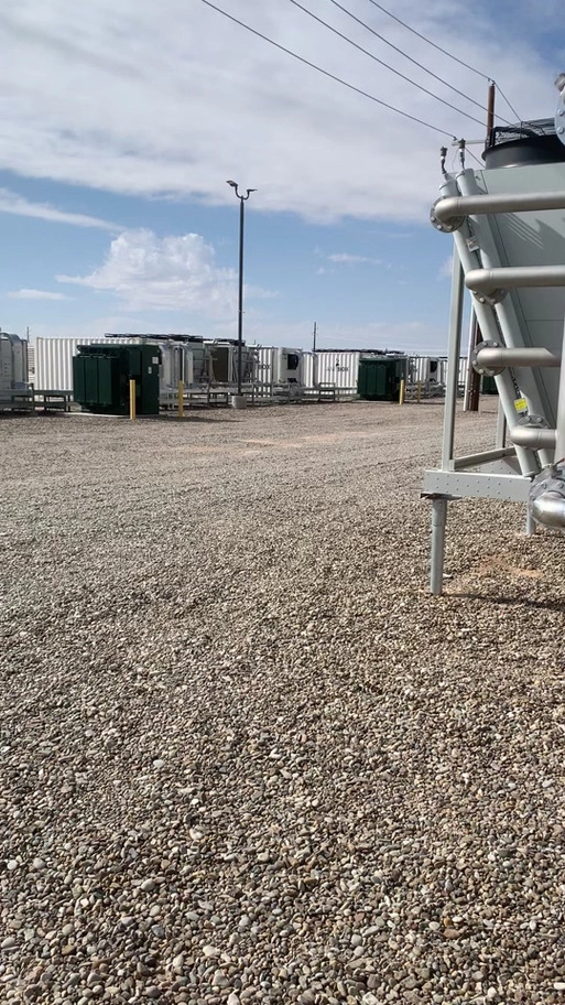 An aerial view of a large-scale mining farm with rows of mining rigs installed.